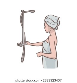 Woman in a bathrobe taking a shower (turning on the water tap)