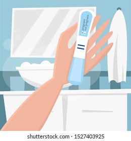 Woman in the bathroom holding in hand a blue pregnancy test with positive result as a two lines