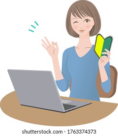 A woman with a beginner's mark in front of a computer is giving an OK sign