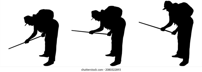 The woman bent down and works with a stick, defending herself with a stick. Black female silhouette on a white background in a cap with a bag on her back. The hand with the stick is down. Side view.