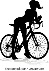 A woman bicycle riding bike cyclist in silhouette