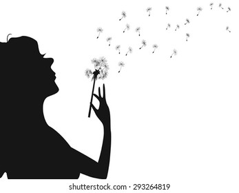 woman blowing dandelion