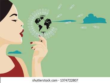 woman blowing the plastic of the planet in a green background