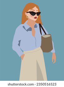 A woman in a blue shirt and white trousers. Fashionable style in clothes for summer or warm autumn. Business lady wearing sunglasses and a bag. Portrait of a red-haired beautiful girl