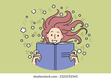 Woman with book lies on meadow reading favorite novel and enjoying onset of summer days. Happy girl with smile rests on meadow with flowers and holds textbook to prepare for entrance exams