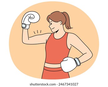 Woman boxer shows biceps and smiles demonstrating strength and determination to defeat opponent. Girl boxer in boxing gloves and sportswear poses at weigh-in ceremony before important tournament