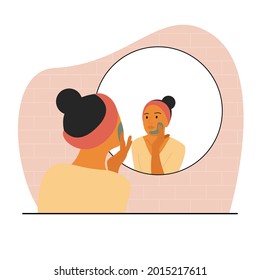 A woman with brown skin sits in front of a mirror and applies a mask to her face. Home cosmetic routine before bed. A woman with a bandage on her head. svg