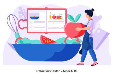 A woman with a bun in an apron carries an apple for cooking. Female chef is preparing salad according to recipe from cookbook. An expanded cookbook with recipes of dishes. Preparation of salad in bowl