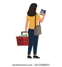 Woman buying groceries at the store, she is carrying a shopping basket full of products and holding a pasta box, back view