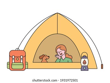 A woman is camping with her dog. The woman and the dog are resting in the tent. flat design style minimal vector illustration.