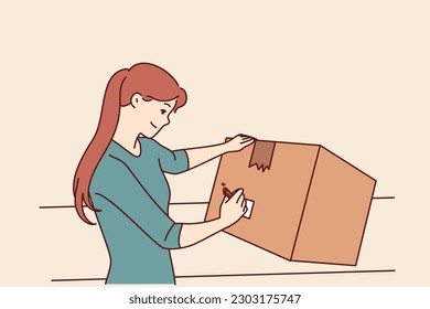 Woman with cardboard box signs package before sending goods through postal service or courier company. Young girl with big box packs household items when moving or renovating apartment