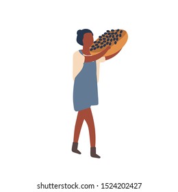 Woman carrying fruit harvest flat vector illustration. Summer and autumn crop gathering. Dark skin female farmer holding basket with grapes cartoon character. Organic berry buying design element.