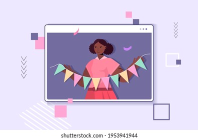 woman celebrating online birthday girl in computer window holding colorful paper bunting party flags