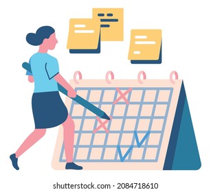 Mujer revisando las tareas completadas en el calendario con un lápiz grande