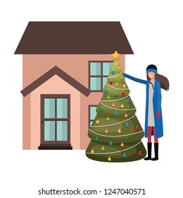woman with christmas tree outside the house