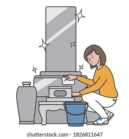 A woman cleaning the grave with a rag.