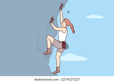 Woman climbs steep cliff to conquer difficult peak without insurance and set new record. Purposeful female rock climber with extreme hobby climbs crag wanting to get new dose of adrenaline 