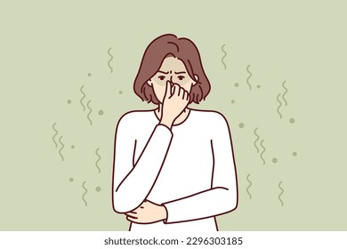 Woman closes nose in disgust at smell and toxic aroma caused by violation of hygiene rules. Young girl in white sweater feels stink and bad smell of clothes or socks in need of washing