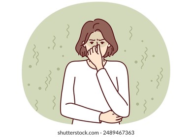 Woman closes nose in disgust at smell and toxic aroma caused by violation of hygiene rules. Young girl in white sweater feels stink and bad smell of clothes or socks in need of washing