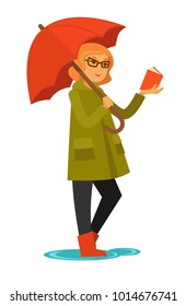 Woman in coat and rubber boots stands under umbrella