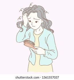 A woman combs her hair and finds that she has lost her hair, grabbing the hair in one hand and holding the comb in the other,
Very worried expression