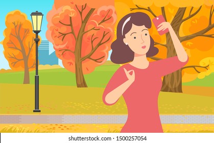 Woman communication with wireless device, female using phone. Girl standing in park with smartphone, internet connection, pretty lady outdoor, yellow autumn trees. Lady do selfie in autumnal park