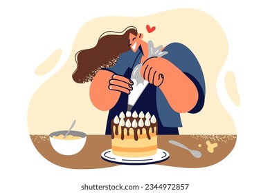 Woman confectioner decorates cake with butter cream making dessert for birthday party celebration. Girl uses pastry bag when preparing cake ordered by client, stands in kitchen of bakery or restaurant