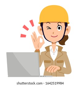 A woman in the construction industry who operates a computer with an OK sign , beige clothes