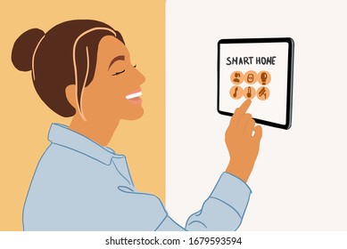 Woman Controlling Home With A Digital Touch Screen Panel Installed On The Wall Indoors. Concept Of A Smart Home. Colorful Vector Illustration In Flat Cartoon Style