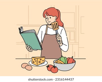 Woman with cookbook is standing in kitchen wanting to cook delicious dinner and vegetables and cheese with eggs. Girl cook in apron uses cookbook while preparing salad or appetizers