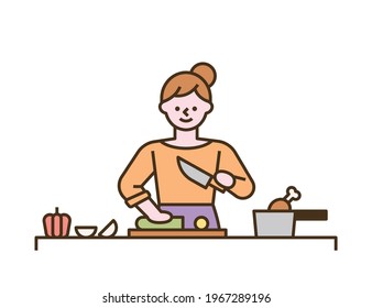 A woman is cooking by chopping vegetables on a cutting board. flat design style minimal vector illustration.