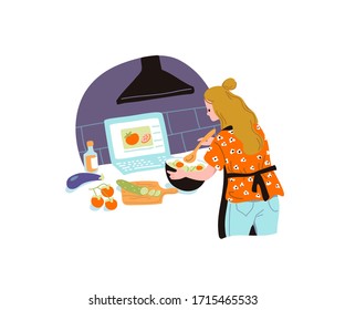 Woman cooking in the kitchen with laptop on the table. Watching a cooking video tutorial. 