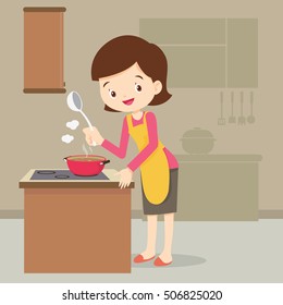 woman cooking and presenting at kitchen.woman with apron happy cooking delicious stew.