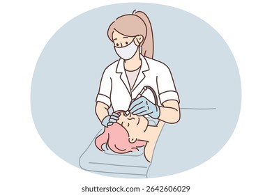 Woman cosmetologist performs microdermabrasion procedure or mechanical peeling and diamond face polishing. Girl visits beautician to get rid of wrinkles or clear skin of acne and pimples