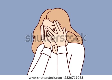 Woman covers eyes with hands and peeps, refusing to see unpleasant things and hiding from problems. Cute girl coquettishly covers face and peeps at your actions through crack in fingers ストックフォト © 