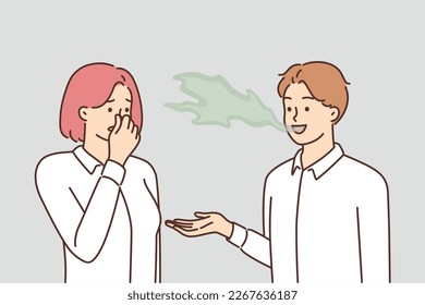 Woman covers nose with hand, feels discomfort communicating with man due to bad breath. Guy with bad breath not brushing teeth causes problems for others after refusing toothpaste svg