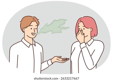 Woman covers nose with hand, feels discomfort communicating with man due to bad breath. Guy with bad breath not brushing teeth causes problems for others after refusing toothpaste