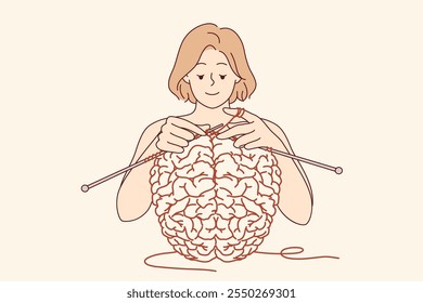Woman creates brain using knitting as metaphor for psychological therapy and mental health care. Girl works on developing brain and memory or intelligence, helping to achieve mental stability