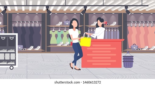 woman customer buying new handbag at cash desk counter fashion shop cloth store female shopping mall modern boutique interior flat horizontal