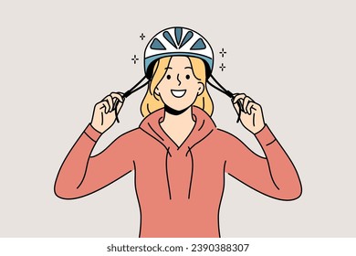 Woman cyclist puts protective helmet on head before cycling to protect against injuries from falls. Girl lover cycling advocates use of hardhat to avoid accidents that could lead to hospitalization.