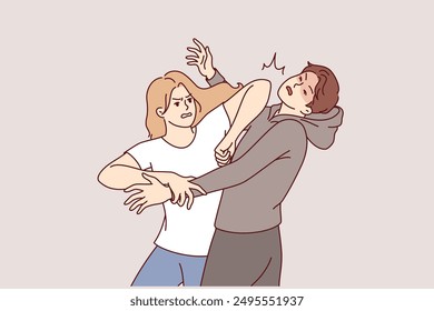 Woman demonstrates self-defense technique by striking man in face pretending to be maniac or robber. Self-defense lessons for girls who want to have sense of security when meeting attacker