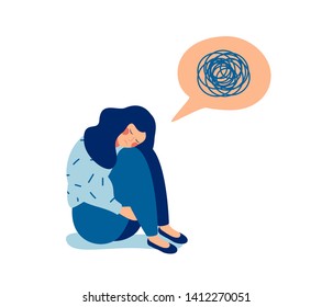 Woman in depression with bewildered thoughts in her mind. Young sad girl sitting and unhappy hugging her knees.