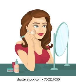 Woman does make-up infront of mirror. Beautiful young woman with red lips.