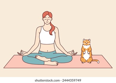 Woman does yoga with cat, meditating in lotus position from zen or asana practice. Pet imitates owner who is keen on yoga and training from buddhist teachings to achieve psychological comfort