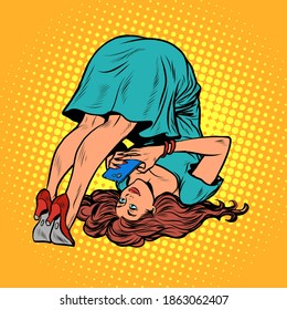 A woman does yoga and communicates on a smartphone. pop art retro vector illustration kitsch vintage drawing 50s 60s style