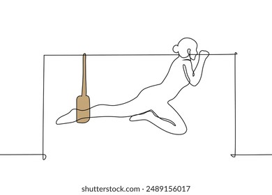 woman doing Pilates on a machine - one line art vector. leg stretching concept. Handmade vector not AI