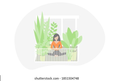 Woman doing yoga on her balcony in lotus position surrounded by plants in social distancing times. Isolation and quarantine in 
 coronavirus global pandemic. Urban jungle and yoga on the terrace