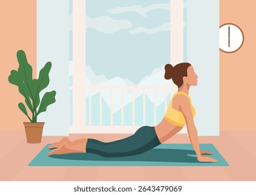 Woman doing yoga on a mat in upward facing snake pose near a window with a mountain view at home for morning fitness routine.
