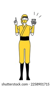 A woman dressed up as a ninja holding a calculator and pointing.