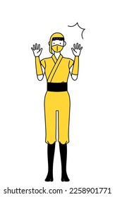 A woman dressed up as a ninja raising her hand in surprise.